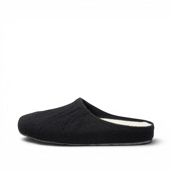 Baabuk Alpina minimalist black wool slip-on sandal with a cork insole and rubber outsole, side view.