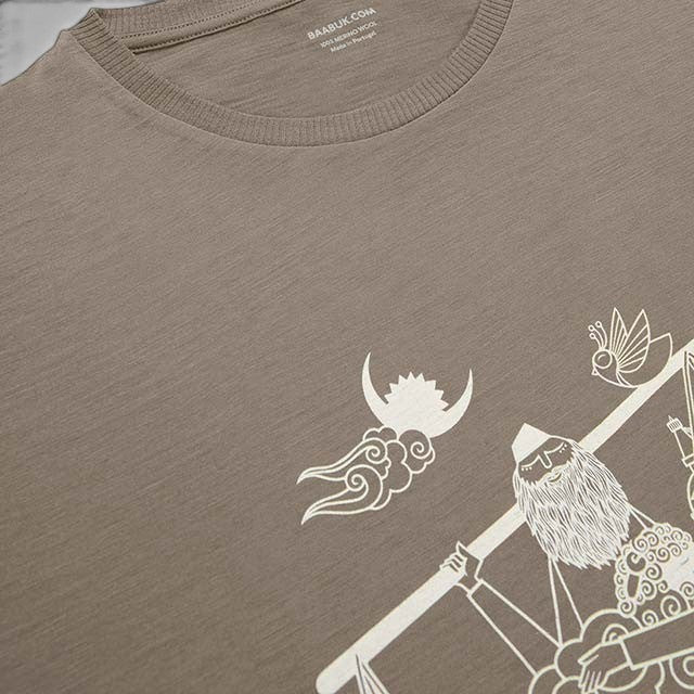 Baabuk 10th anniversary khaki merino wool t-shirt with white Nepalese-inspired graphic illustration.