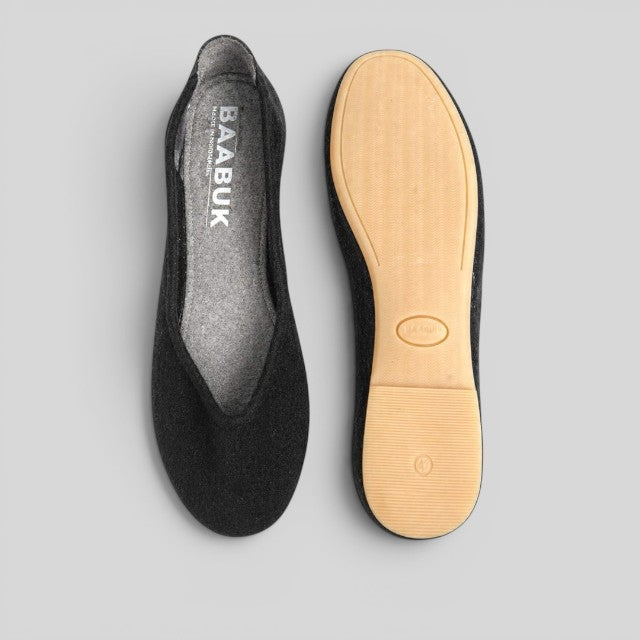 Baabuk black wool ballerina flats showing top view and durable rubber sole on a grey background