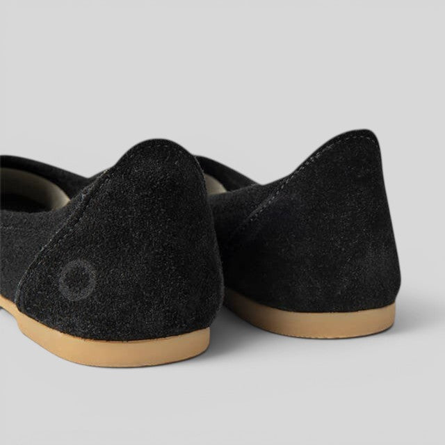 Baabuk black wool ballerina flats featuring a soft sheep wool upper and durable rubber sole, rear view.