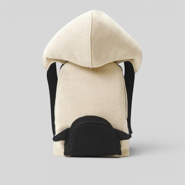 Baabuk Blacknose hooded backpack in cream wool with a black outer compartment and adjustable shoulder straps.