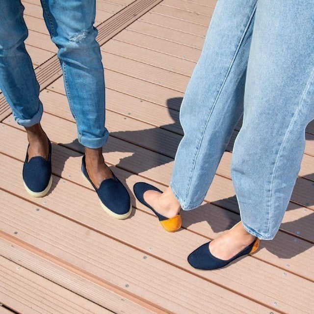 Baabuk blue wool ballerina flats with nubuck heel detail worn by a person on a wooden deck