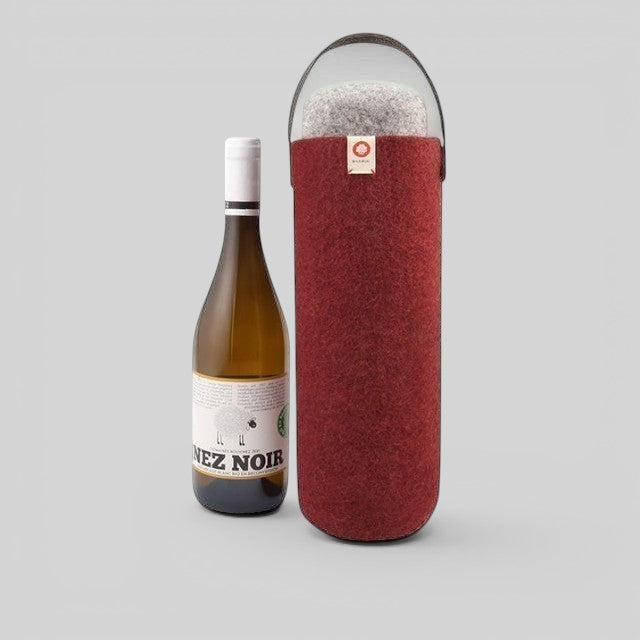 Baabuk Bordeaux wool wine cooler with a leather strap, keeping a wine bottle chilled for outdoor use.