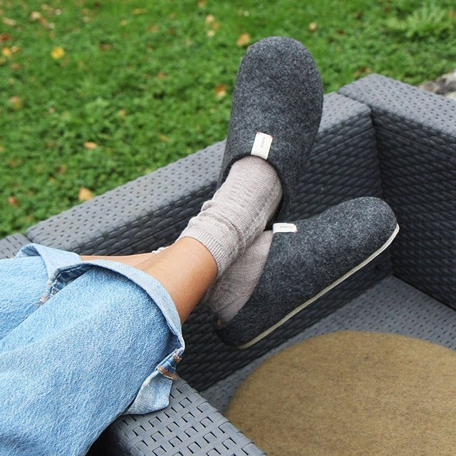 Baabuk Corkybuk dark grey handfelted wool slippers with orthopedic cork soles worn outdoors with socks and jeans.