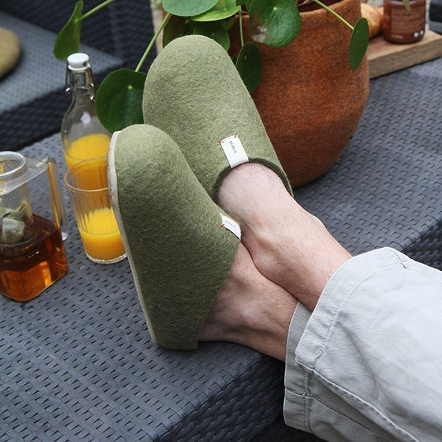 Baabuk Corkybuk khaki green handfelted wool slippers with orthopedic cork soles worn on a patio