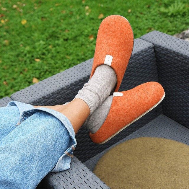 Baabuk Corkybuk terracotta wool slippers with cork soles worn outdoors with grey socks and blue jeans