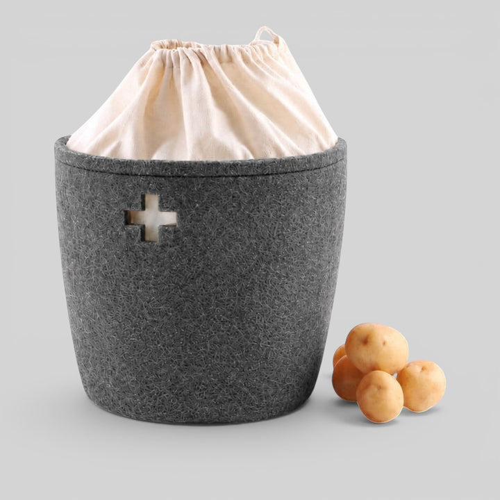 Baabuk large dark grey felted wool basket with a Swiss cross cutout and cream fabric drawstring liner.