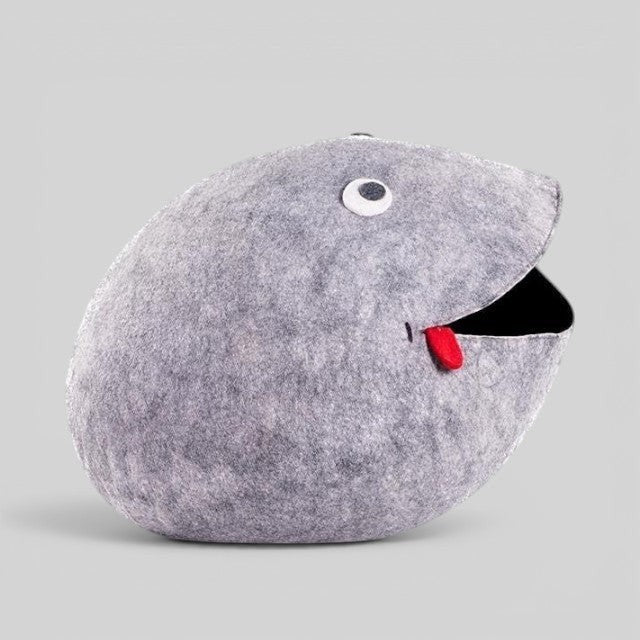 Baabuk handmade grey wool frog storage basket with hand-stitched eye and red tongue detail on a neutral background.