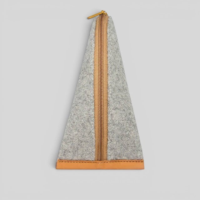 Baabuk grey wool pencil case with a brown leather base and matching zipper closure on a neutral background.