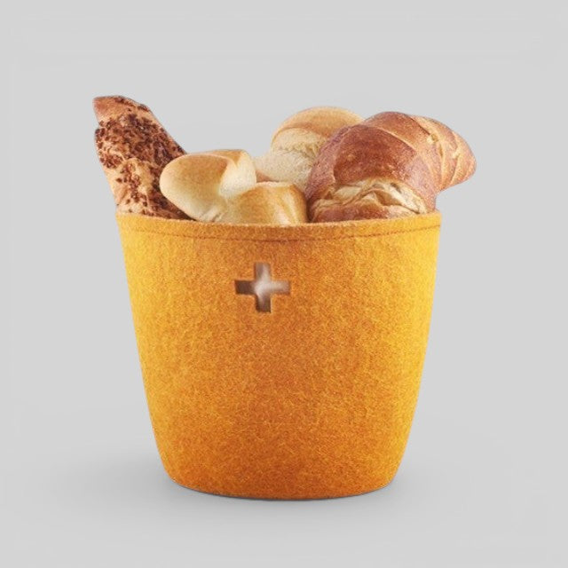 Baabuk small honey-coloured felted wool basket filled with bread, featuring a Swiss cross cutout design.