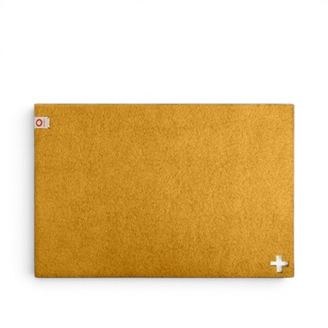 Baabuk honey yellow rectangular felted wool table mat with a small Swiss cross cutout detail.
