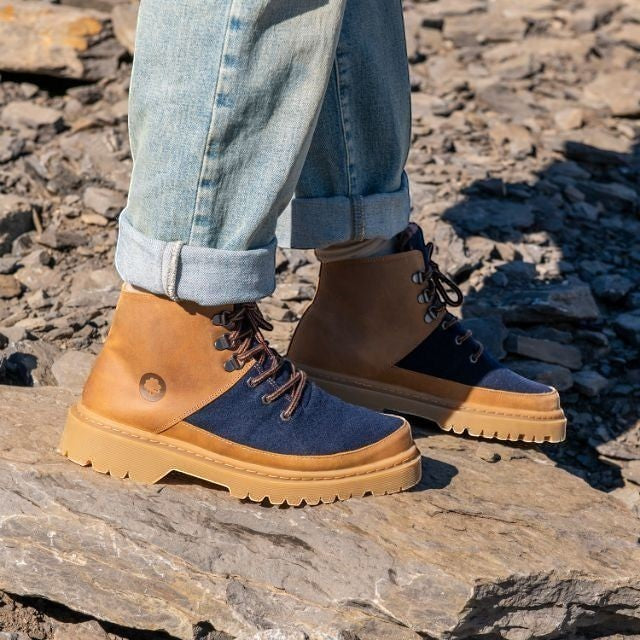 Baabuk Ice Wooler boots in navy wool and brown nubuck leather with a rugged rubber sole worn on rocky terrain.