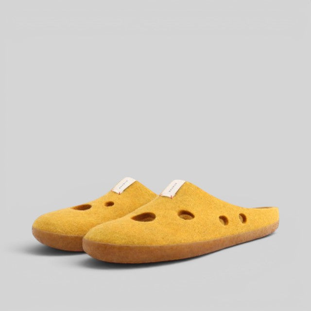 Baabuk Kanga slippers in yellow wool with Swiss cheese-inspired hole cutouts and a natural latex sole.