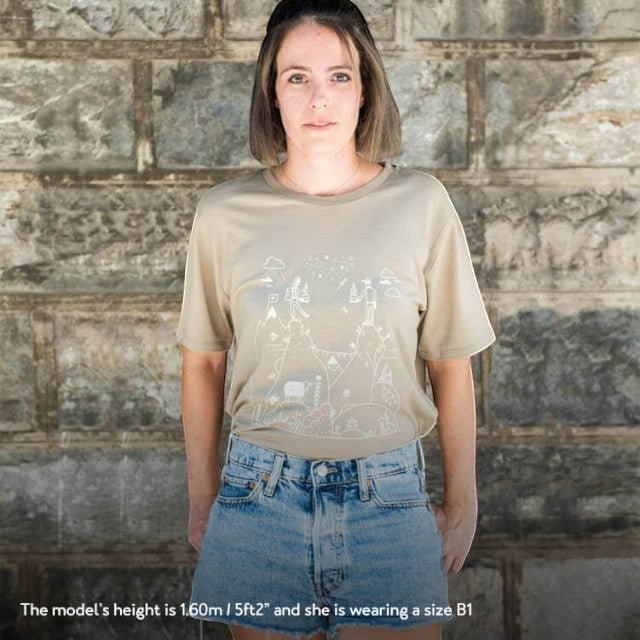 Model wearing a khaki Baabuk 10th anniversary merino wool t-shirt with a white Swiss-themed graphic illustration.
