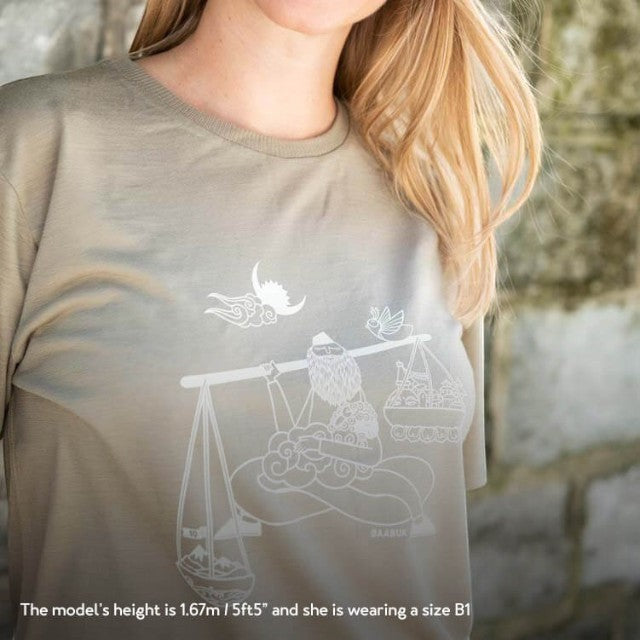 Baabuk limited edition khaki merino wool t-shirt with white Nepalese artist illustration, worn by a model.