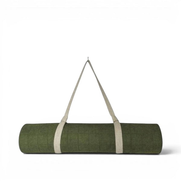 Baabuk khaki felted wool yoga mat rolled up with a natural cotton carrying strap against a white background.