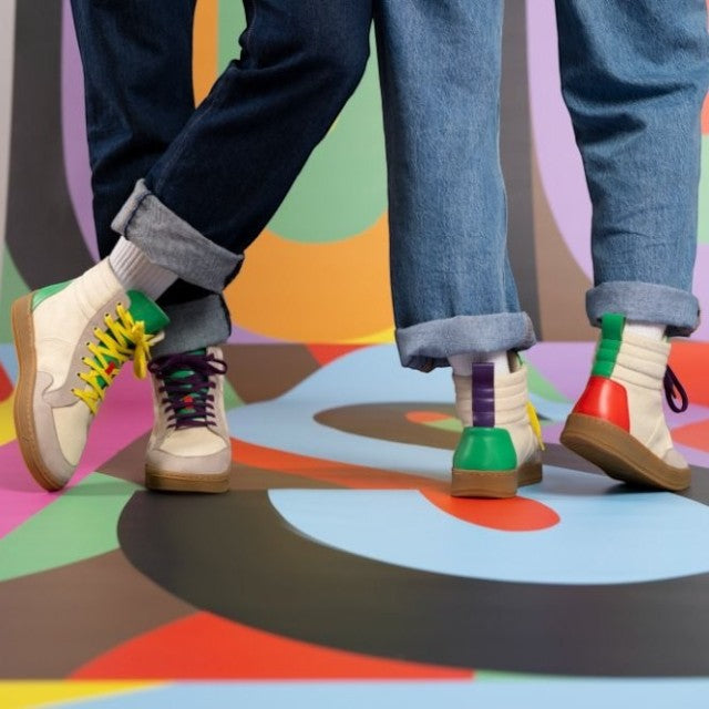 Baabuk Lakeside Wooler sneakers in cream wool with colorful leather accents and rubber soles worn by two models.