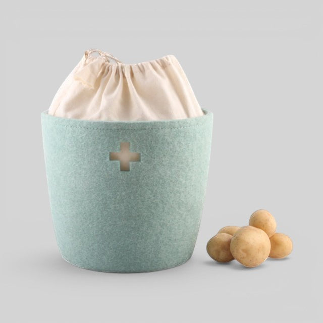 Baabuk small light blue felted wool basket with a Swiss cross cutout and cream fabric drawstring liner.