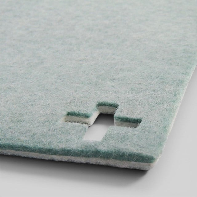 Baabuk light blue felted wool table mat with a Swiss cross cutout detail, handmade from natural New Zealand wool.