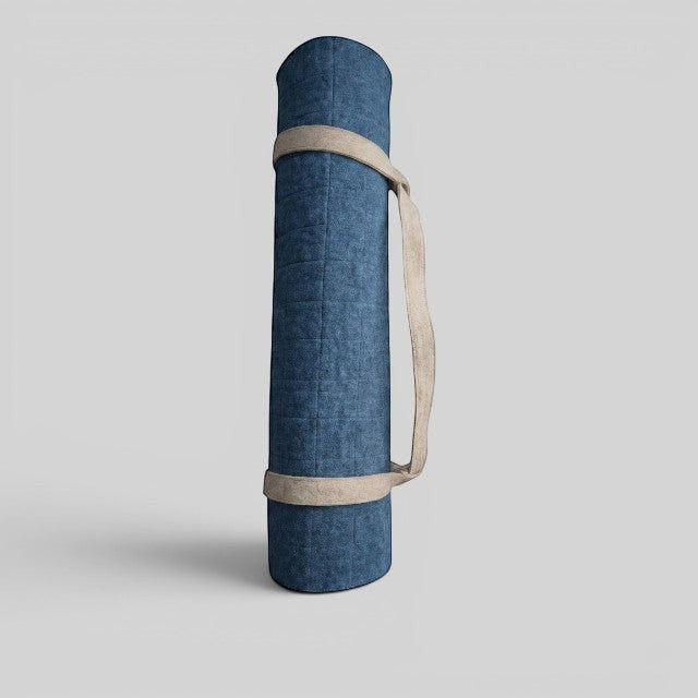 Baabuk light blue felted wool yoga mat rolled up with a beige cotton carrying strap against a plain background