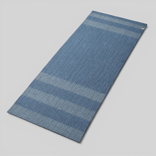 Baabuk light blue felted wool yoga mat with textured striped design and natural cotton stitching