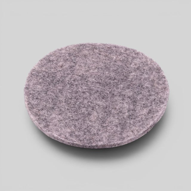 Baabuk light grey round felt coaster made from 100% natural wool for furniture protection