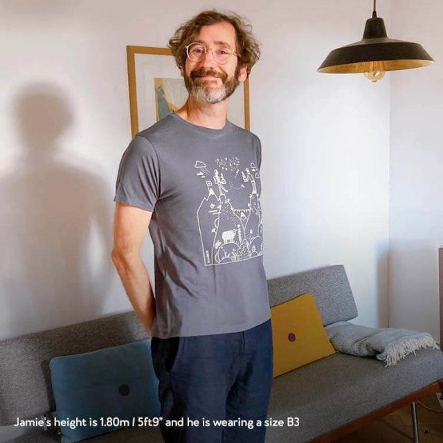 Man wearing a dark grey Baabuk 100% merino wool T-shirt with a white Swiss-themed illustration by Jamie Aspinal.