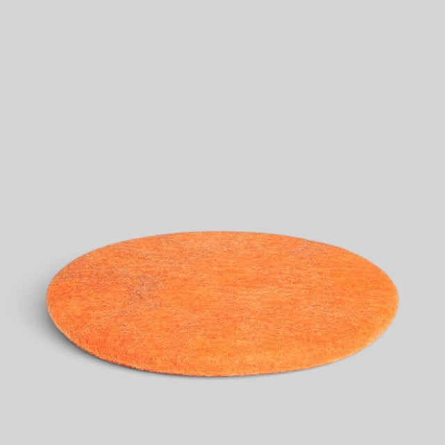 Baabuk handmade orange circular wool sitting mat made from natural New Zealand wool
