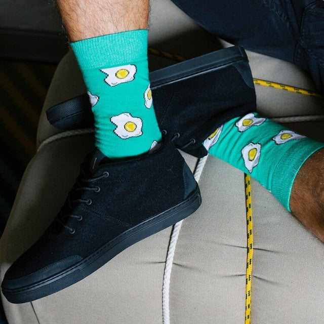 Baabuk Sky Wooler black wool sneakers with black rubber soles worn with green egg-patterned socks