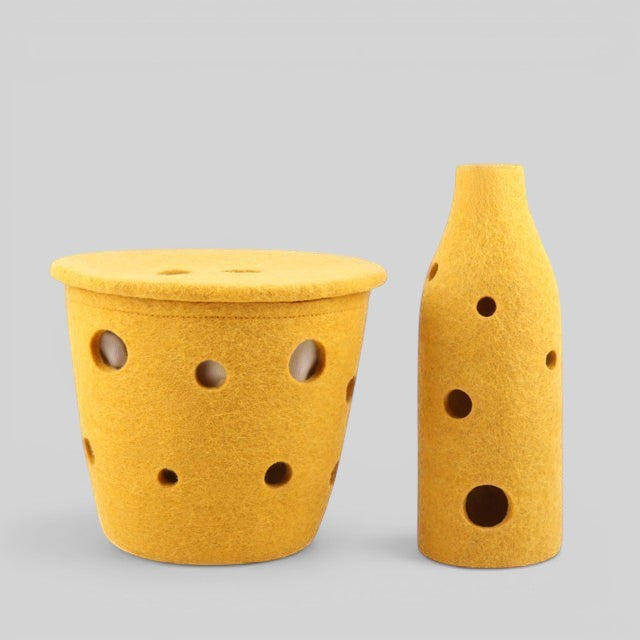 Baabuk Swiss Cheese collection yellow felted wool basket and bottle cover with Swiss-inspired hole design