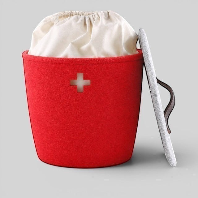 Baabuk Swiss red felted wool basket with a white fabric liner, Swiss cross cutout, and a grey lid with leather strap.