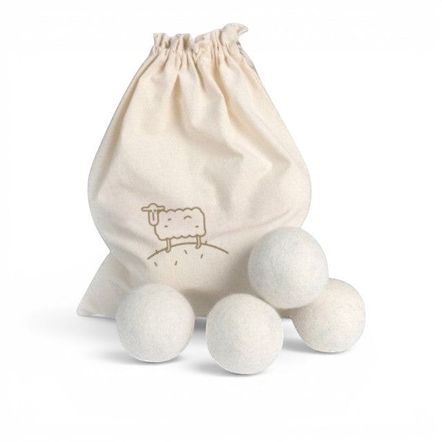 Set of 4 white Baabuk wool dryer balls with a branded cotton drawstring carry bag for sustainable laundry care.