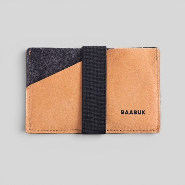 Baabuk slim wallet in grey wool and tan leather with a black elastic strap for secure card and cash storage.