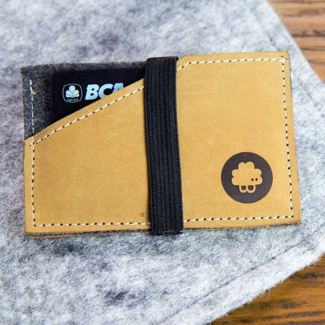 Baabuk slim wallet made of grey wool and tan leather with a black elastic strap and logo detail