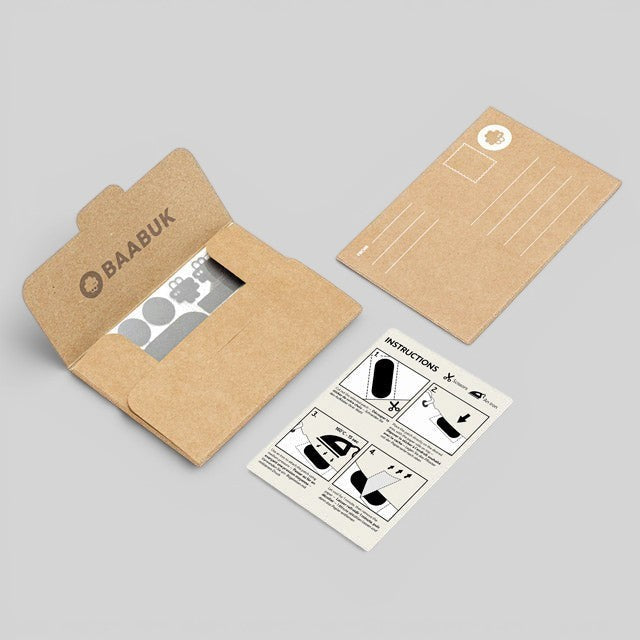 Baabuk repair kit featuring adhesive wool patches, instruction card, and branded kraft paper envelope.