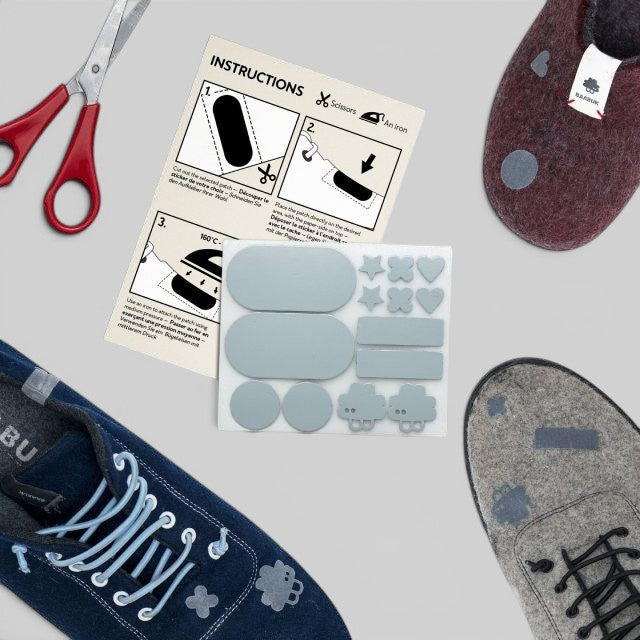 Baabuk repair kit with iron-on felt patches in various shapes and instruction sheet for wool slippers